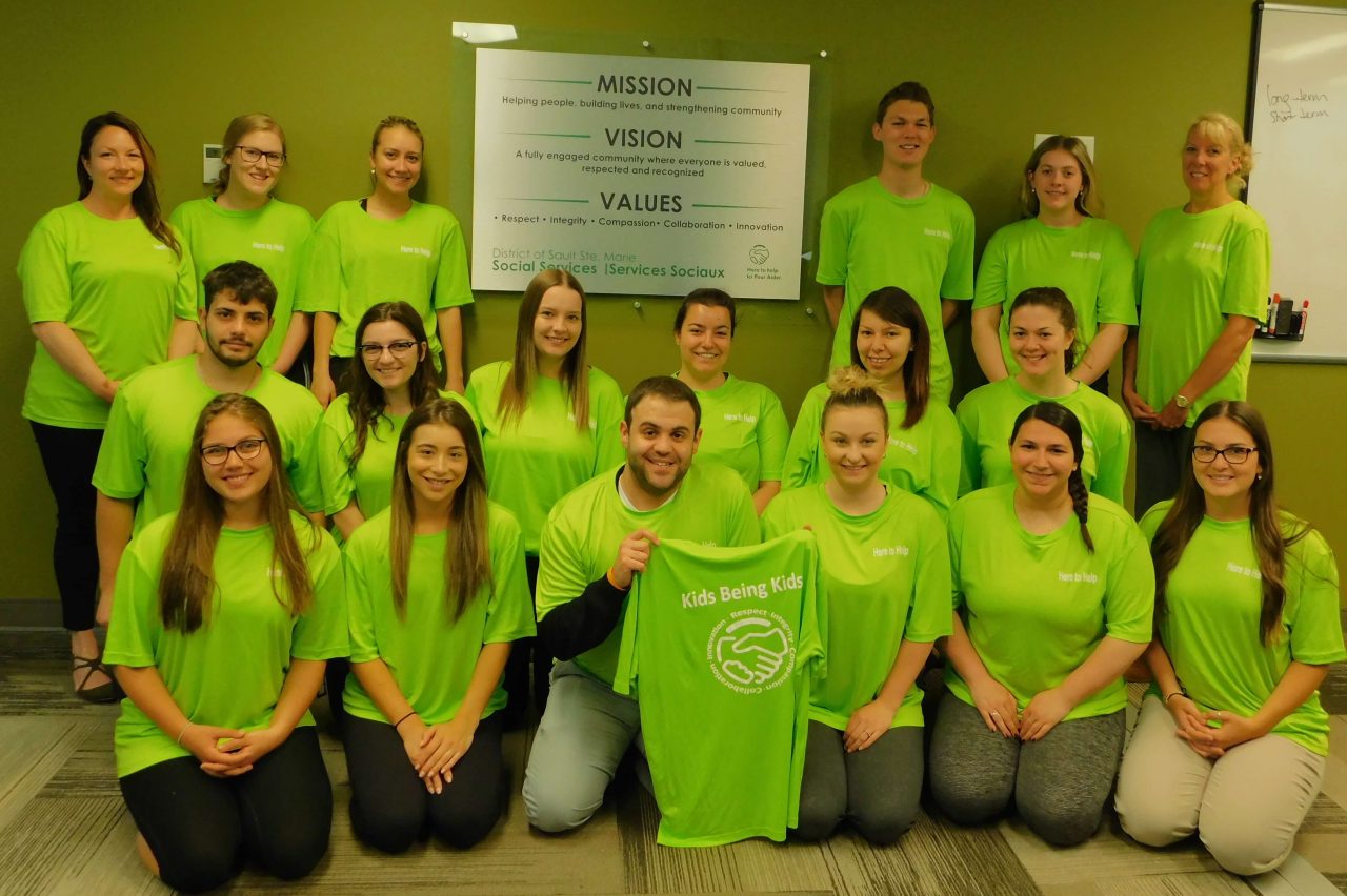 group of students wearing green Kids Being Kids t-shirts
